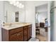 Bright bathroom with vanity and view to the main bedroom featuring gray walls and hardwood flooring at 1468 Blackthorne N Trl, Plainfield, IN 46168