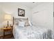 Cozy bedroom features a metal bed frame, light walls, and a side table with lamp at 1468 Blackthorne N Trl, Plainfield, IN 46168