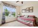 Well-lit bedroom with a daybed, large window view, and neutral decor at 1468 Blackthorne N Trl, Plainfield, IN 46168