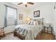 Cozy bedroom with a window, floral bedding, side table, night stand, chair, and carpet flooring at 1468 Blackthorne N Trl, Plainfield, IN 46168