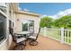 Cozy outdoor deck area with patio furniture and a pleasant view of the yard and blue sky at 1468 Blackthorne N Trl, Plainfield, IN 46168