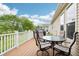 Outdoor deck area with a table, chairs, and view of the backyard and blue sky at 1468 Blackthorne N Trl, Plainfield, IN 46168