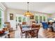 Cozy dining room bathed in natural light, featuring hardwood floors and comfortable seating at 1468 Blackthorne N Trl, Plainfield, IN 46168