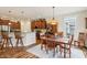 Charming dining room with wood floors, wooden table, and barstool seating at kitchen island at 1468 Blackthorne N Trl, Plainfield, IN 46168