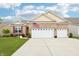 Charming brick home featuring an attached two car garage, manicured lawn, and an American flag at 1468 Blackthorne N Trl, Plainfield, IN 46168