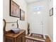Inviting foyer with a decorative wood table, rug, and white front door at 1468 Blackthorne N Trl, Plainfield, IN 46168