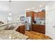 Well-equipped kitchen features stainless steel appliances, granite counters and wood floors at 1468 Blackthorne N Trl, Plainfield, IN 46168