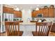 Stylish kitchen boasts stainless steel refrigerator, granite countertops and plenty of wooden cabinetry at 1468 Blackthorne N Trl, Plainfield, IN 46168
