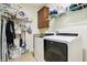 Bright laundry room with modern washer and dryer, shelving, and cabinet storage at 1468 Blackthorne N Trl, Plainfield, IN 46168
