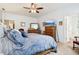 Stylish main bedroom featuring white walls, carpet, wood furnishings, a ceiling fan, and a view to the bath at 1468 Blackthorne N Trl, Plainfield, IN 46168