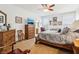 Inviting main bedroom featuring neutral walls, carpet, wood furnishings, decor, and a ceiling fan at 1468 Blackthorne N Trl, Plainfield, IN 46168
