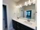 Bathroom featuring dual sinks, granite countertops, and tiled floor at 17399 Dovehouse Ln, Westfield, IN 46074