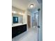 Bathroom featuring dual sinks, granite countertops, and tiled floor at 17399 Dovehouse Ln, Westfield, IN 46074