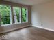 Bright bedroom with beautiful hardwood floors and three large windows overlooking lush greenery at 17399 Dovehouse Ln, Westfield, IN 46074