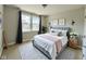 A modern bedroom showcasing a gray bed frame, plush bedding, and natural light from large windows at 17399 Dovehouse Ln, Westfield, IN 46074