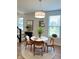 Cozy dining area features a round table, modern lighting, and views of the outdoors at 17399 Dovehouse Ln, Westfield, IN 46074
