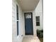 Inviting entrance with a stylish navy blue front door, side lights and crisp white trim at 17399 Dovehouse Ln, Westfield, IN 46074