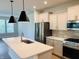 Beautiful kitchen features a large island, stainless steel appliances, pendant lights, and an open layout at 17399 Dovehouse Ln, Westfield, IN 46074