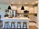 Modern kitchen featuring a spacious island, stainless steel appliances, and stylish pendant lights at 17399 Dovehouse Ln, Westfield, IN 46074