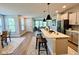 Open-concept kitchen with a large island, stainless steel appliances, and modern pendant lighting at 17399 Dovehouse Ln, Westfield, IN 46074