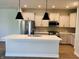 Bright kitchen features stainless steel appliances, a large island, pendant lights, and shaker cabinets at 17399 Dovehouse Ln, Westfield, IN 46074
