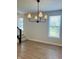 Bright living area features hardwood floors, natural light, and access to a staircase at 17399 Dovehouse Ln, Westfield, IN 46074