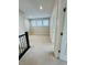 Bright loft area illuminated by natural light, boasting neutral carpeting and walls with entry door at 17399 Dovehouse Ln, Westfield, IN 46074