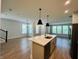 Spacious floorplan with a large kitchen island, plenty of natural light, and wood-look floors at 17399 Dovehouse Ln, Westfield, IN 46074