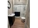 Bathroom with a shower, toilet, sink and dark-wood vanity at 207 E Plum St, Anderson, IN 46012