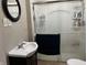 Bathroom with shower, toilet, and sleek sink at 207 E Plum St, Anderson, IN 46012