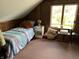 Small bedroom with wood paneling and a twin bed by a bright window at 207 E Plum St, Anderson, IN 46012
