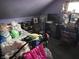 Cluttered bedroom with stuffed animals, a window, and a purple wall at 207 E Plum St, Anderson, IN 46012