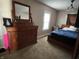 Bedroom featuring a bed with blue bedding and a large wooden dresser at 207 E Plum St, Anderson, IN 46012