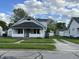 Quaint two-story home with a covered porch and well-kept front lawn at 207 E Plum St, Anderson, IN 46012