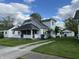 Charming two-story home featuring a front porch, well-maintained lawn, and a separate garage at 207 E Plum St, Anderson, IN 46012