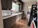 Cozy kitchen featuring plenty of counter space and cabinets with black appliances at 207 E Plum St, Anderson, IN 46012