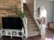 Stylish living room with hardwood floors, open staircase, and an arched entrance into another room at 207 E Plum St, Anderson, IN 46012