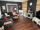Stylish living room with dark walls, fireplace, hardwood floors and comfortable seating at 207 E Plum St, Anderson, IN 46012
