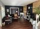 Bright living room with dark walls, fireplace, hardwood floors and comfortable seating at 207 E Plum St, Anderson, IN 46012