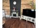 Cozy living room with a wooden accent wall and stylish fireplace at 207 E Plum St, Anderson, IN 46012