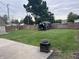 Large grassy back yard features a shed, wood fence and concrete patio at 2208 S F St, Elwood, IN 46036