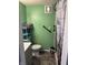 Bathroom features green walls, tile floors, grab bars and a combination shower and toilet at 2208 S F St, Elwood, IN 46036