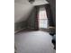 Carpeted bedroom with sloped ceilings, a dormer window with curtains and two-tone paint at 2208 S F St, Elwood, IN 46036