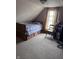 Bedroom with neutral carpeting, dormer window, light walls and storage drawers under the bed at 2208 S F St, Elwood, IN 46036