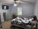 Comfortable bedroom featuring neutral walls, ceiling fan, and a sunny window at 2208 S F St, Elwood, IN 46036
