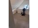 Bonus room features neutral carpeting, an exercise machine, window and sloped ceilings at 2208 S F St, Elwood, IN 46036