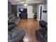 Inviting living room with cozy gray seating, wood floors, and a sliding barn door at 2208 S F St, Elwood, IN 46036