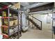 Unfinished basement with ductwork, shelving, storage and access to the upper floors at 236 W 33Rd St, Indianapolis, IN 46208