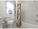 Bright bathroom features white subway tile shower with ornate shower curtain and adjacent toilet at 236 W 33Rd St, Indianapolis, IN 46208