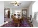 Open-concept dining room with hardwood floors, a ceiling fan, and a display cabinet at 236 W 33Rd St, Indianapolis, IN 46208